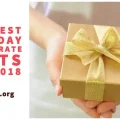 The Best Holiday Corporate Gifts for 2018 - Hands holding a yellow gift box with bow and ribbon.