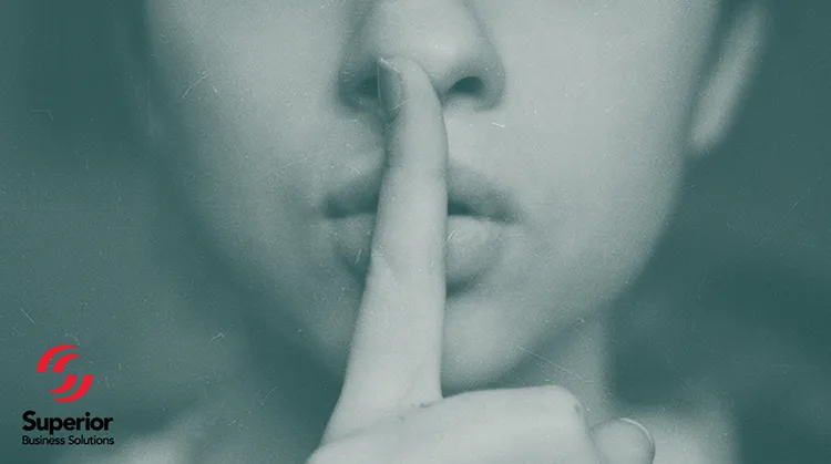 A woman with a secret, holding index finger up to lips