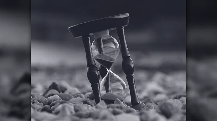 Hourglass embedded in stones - Time Savings metaphor