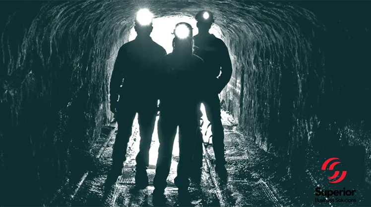 Miners with headlamps in tunnel